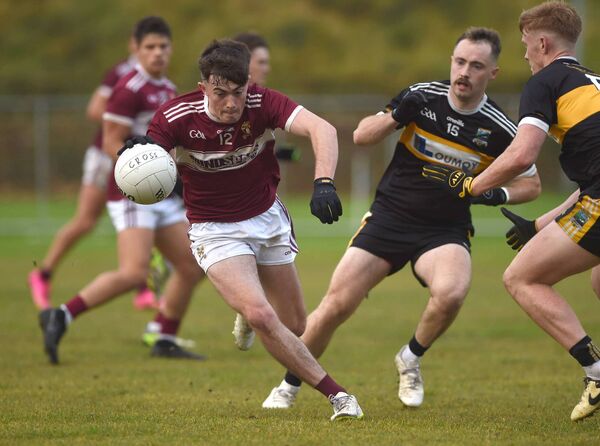 Crossmolina's Niall Goggins tries to avoid the tackle of Louisburgh's Isaac O'Grady. Picture: Conor McKeown Crossmolina's Niall Goggins tries to avoid the tackle of Louisburgh's Isaac O'Grady. Picture: Conor McKeown