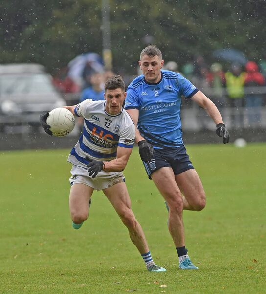 Davitt Neary of Breaffy holds off the challenge of Westport defender Brian McDermott. Davitt Neary of Breaffy holds off the challenge of Westport defender Brian McDermott.