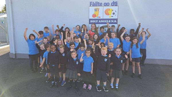 The current National School Children of the Holy Angels N S in Clogher pictured with local girl and Champion Handballer Cuilleann Bourke.