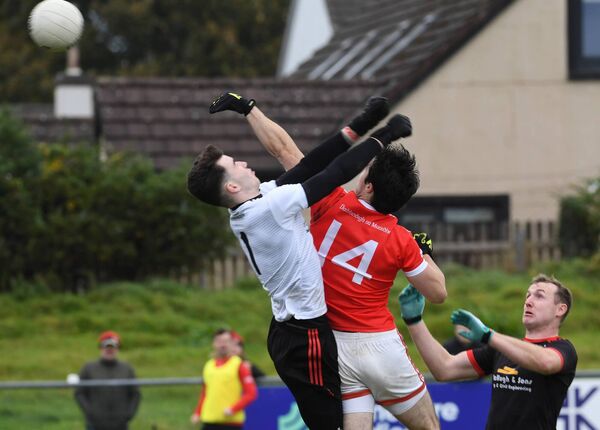 Brian Reape fists the ball towards goal despite the best efforts of Davitts goalkeeper Dylan O’Brien and full-back Cathal Higgins. The Moy Davitts attacker saw his effort strike the crossbar. Brian Reape fists the ball towards goal despite the best efforts of Davitts goalkeeper Dylan O’Brien and full-back Cathal Higgins. The Moy Davitts attacker saw his effort strike the crossbar.