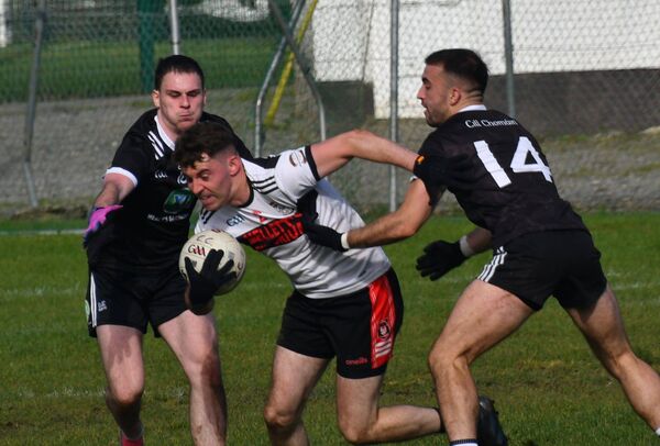 Swinford defender Alan McLoughlin makes for a gap between Cill Chomáin's Lorcan Mason and Justin Healy. Picture courtesy of Michael Maye/Mayo GAA Swinford defender Alan McLoughlin makes for a gap between Cill Chomáin's Lorcan Mason and Justin Healy. Picture courtesy of Michael Maye/Mayo GAA