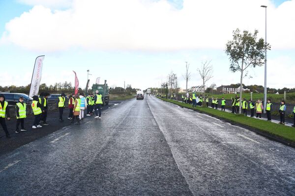 The students lined up on both sides of the busy Killala Road in Ballina. Picture: John O'Grady