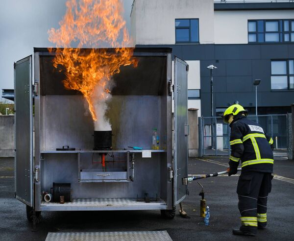 Fireman Bernard Pidgeon demonstrates the effect of attempting to extinguish a chip-pan fire by adding water.