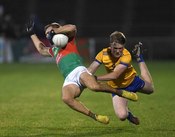 Knockmore’s Oliver Armstrong tackles Luke Doherty of Ballina Stephenites. Picture: David Farrell Photography Knockmore’s Oliver Armstrong tackles Luke Doherty of Ballina Stephenites. Picture: David Farrell Photography