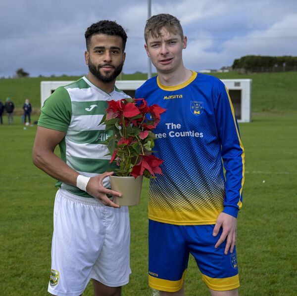 As a mark of respect for the victims of recent accidents and tragedies in Cloonfad, Jordan Loftus presents a floral tribute on behalf of Castlebar Celtic to Matty Freyne of Cloonfad United. As a mark of respect for the victims of recent accidents and tragedies in Cloonfad, Jordan Loftus presents a floral tribute on behalf of Castlebar Celtic to Matty Freyne of Cloonfad United.