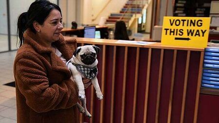 In Pictures: Voters and a pug cast their ballots in the general election