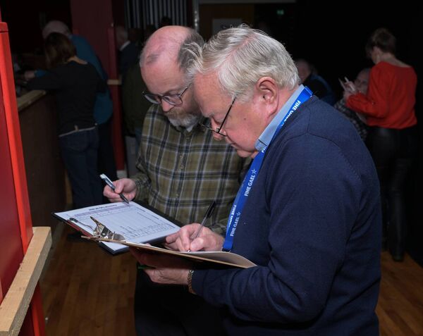 Jotting down the tallies. Jotting down the tallies.