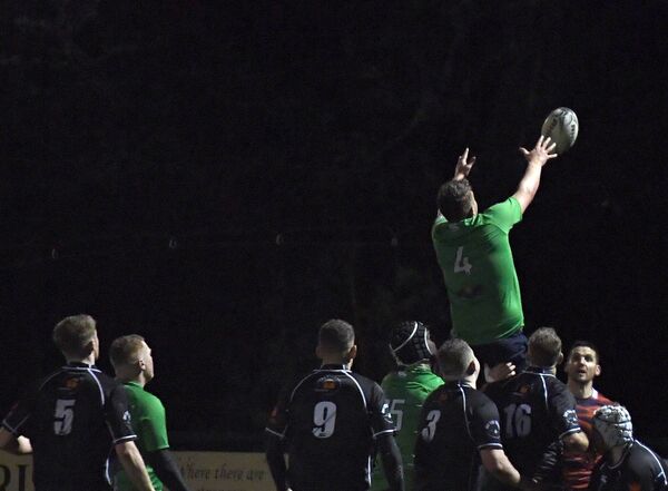 A striking image of Ballina’s Gerard McKenna as he soars against a blackened skyline in atrocious conditions during the match in Heffernan Park last Saturday night. Picture: David Farrell