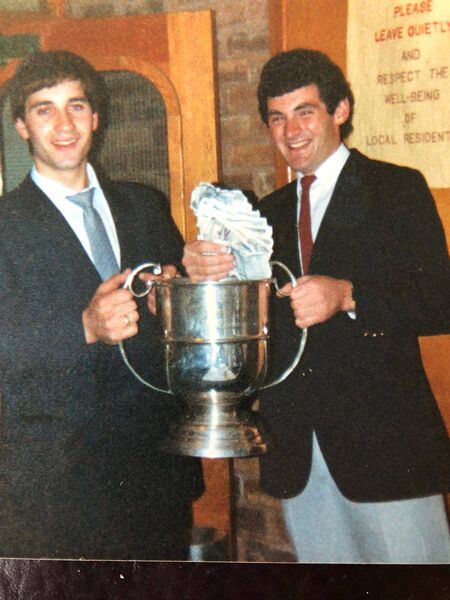 Ballycroy players Peter Cafferkey (left) and Seán Conway pictured at the Ballycroy reunion dinner dance in Camden Town, London, in the winter of 1987 with the McHale Cup they won earlier that year. They’re holding the proceeds of an impromptu collection on the night which helped cover the bank loan they took out that year.	Picture courtesy of Seán Conway 