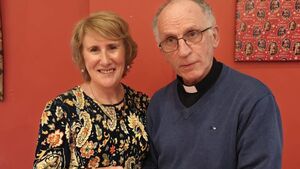Local Notes: Fr Gerry and Carmel cut the cake at Cooneal Community Christmas Party.