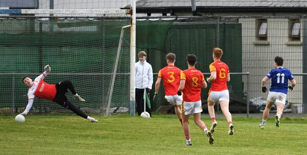 Castlebar Mitchels goalkeeper Peter Basquille superbly saves the goal effort of Craig Cassidy of Claremorris, (11), during the Mayo U-21 A football semi-final at Claremorris last Sunday. 