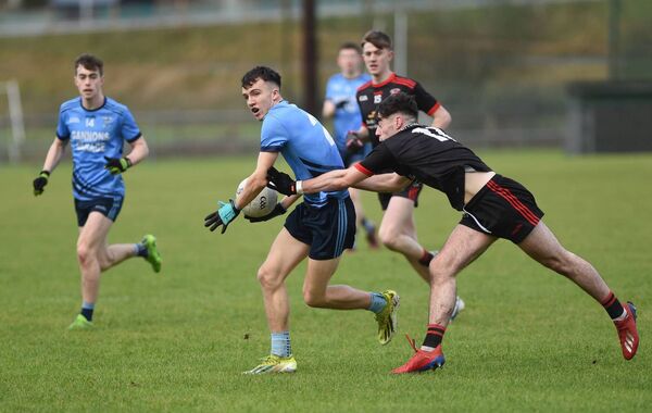 Westport's Tom Lambert tries to hold off the challenge of Davitts' Jack Melvin.