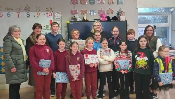 Sr Maureen Lally, centre back, judge of the Anti-Litter Poster competition, with members of Clogher Environmental Group who organised the competition and the children whose posters were chosen for the calendar.