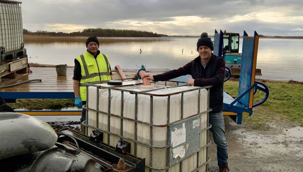 Volunteerism at its best - Paddy McGing on the left voluntarily providing his machinery to assist people in the Carnacon area with a water supply from Lough Carra for animals and toilets. Pierce Corbett was delighted to avail of the facility. Picture by Tom Quinn