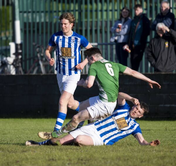 Castlebar Celtic's Oran Groarke on the end of a crunching tackle from Shane Cox of Maree/Oranmore. 