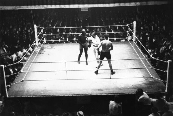 French referee (and champion boxer) Georges Carpentier intervenes during the bout between Jack Johnson (left) and Frank Moran in Paris in June 1914. Picture: Central Press/Getty Images French referee (and champion boxer) Georges Carpentier intervenes during the bout between Jack Johnson (left) and Frank Moran in Paris in June 1914. Picture: Central Press/Getty Images