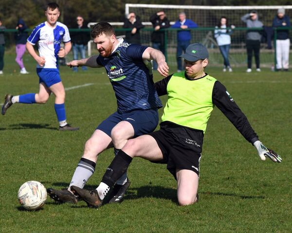 Glenhest Rovers’ Connor McCarthy in a sliding tackle with Ballina Town goalkeeper Aaron Reilly during the Mayo Super League at Belleek last Sunday morning. Picture: David Farrell Photography 