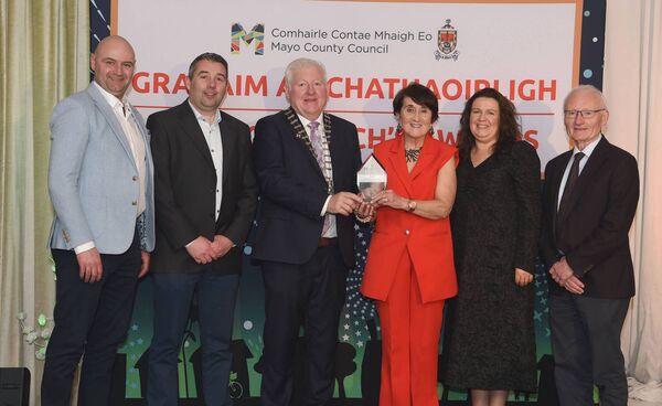 Pictured at the Cathaoirleach’s Awards 2024 being presented with their award by Cathaoirleach Cllr John O’Hara were the winners of the Irish Language Initiative of the Year CLG Coillte Mach.