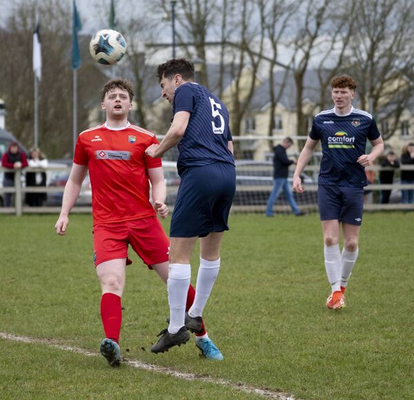 Glenhest Rovers defender Adrian Rowland heads the ball away with Ballinrobe Town's Oisin Hanlon in pursuit. Picture: John Corless