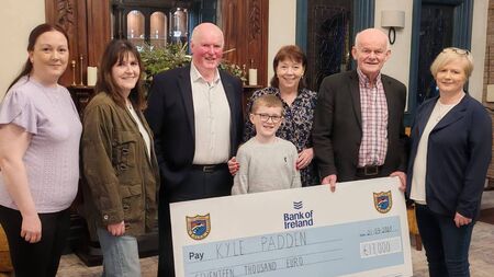 Local Notes: Kiltane GAA Club present cheque to lotto jackpot winner.