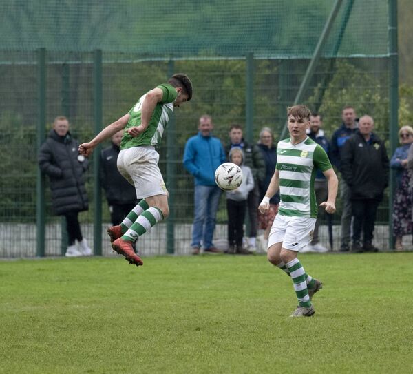Castlebar Celtic's Johnnie Cocozza heads down to teammate Cathal Coyne. Picture: John Corless
