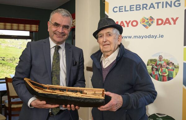Packie O'Toole, a well-known currach builder on Inishturk Island, presented Minister Calleary with one of his model currachs.  