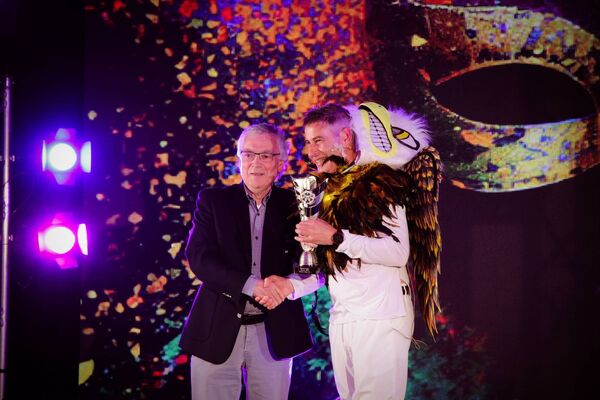 Colm McLoughlin, winner of the Ballina Town FC Masked Singer fundraiser, is presented with his prize by Club President, Gerry Kenny. 