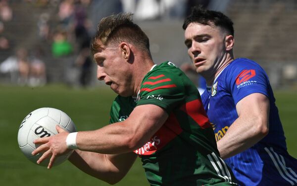 Mayo’s Ryan O’Donoghue breaks away from Cavan’s Niall Carolan. 