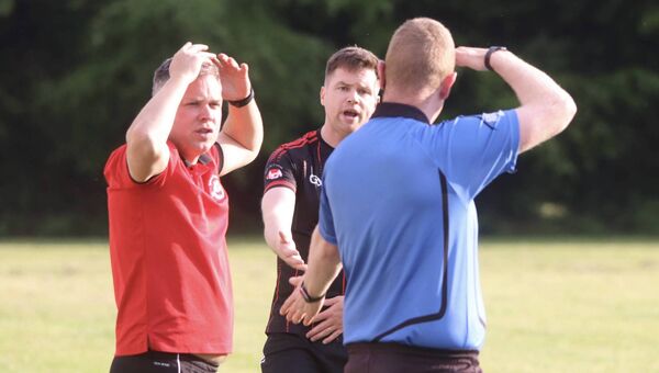 Ballintubber senior team management Alan Plunkett and Damien Coleman react with disbelief to being told by the fourth official that the present fine spell of weather is coming to an end! Picture by Tom Quinn