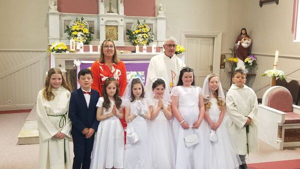 Pupils from Logboy National School are photographed with teacher Bernie Connell and Bekan parish priest Fr Brendan McGuinness after their First Holy Communion ceremony.