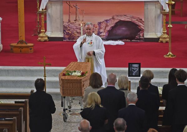  Fr John Kenny saying the prayers over the remains of poet Paul Durcan before his burial in Aughavale Cemetery in Westport. Picture: Conor McKeown