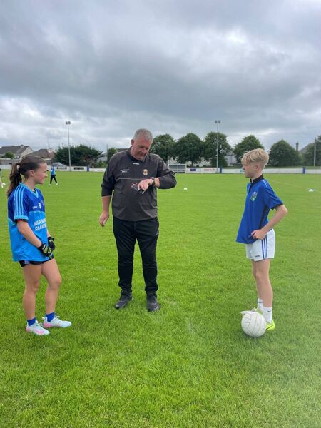 Team captains Amelia Cummins and Kyle Gleeson with referee Martin Costello before the start of the inaugural School League Final at Claremorris National School. 