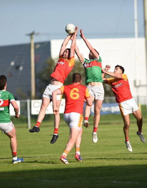 Conor Stenson of Castlebar Mitchels contests possession at midfield with Ballina's Luke Feeney.