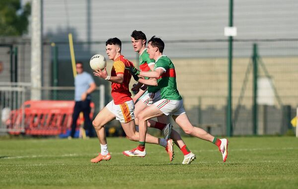 Ballina's Brendan Collins and Ciaran Boland give chase to Castlebar attacker Cian Walsh.