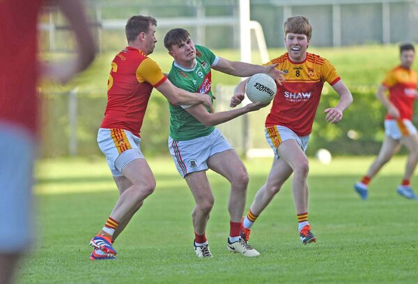 Frank Irwin of Ballina is tackled by Castlebar's Eoghan O'Reilly. 