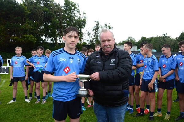 West Mayo GAA treasurer John Gibbons presents Westport captain Paddy Ketterick with the cup (sponsored by the Castlecourt Hotel) following the West Mayo U14 'A' final. 