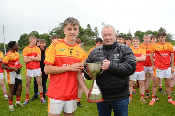 John Gibbons, treasurer of the West Mayo GAA Board, presents Fionn McHale with the division's minor 'A' cup, named in memory of Joe Staunton, following Castlebar Mitchels' victory over Na Fianna - an amalgamation of Burrishoole and Islandeady.