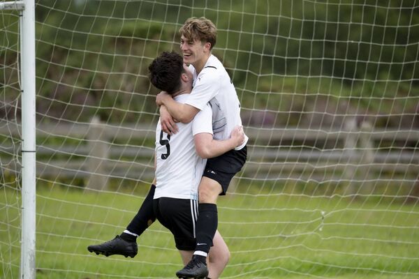 Seán Rabbette lifts Adam Blake as the Ballyheane goalscorers celebrate.