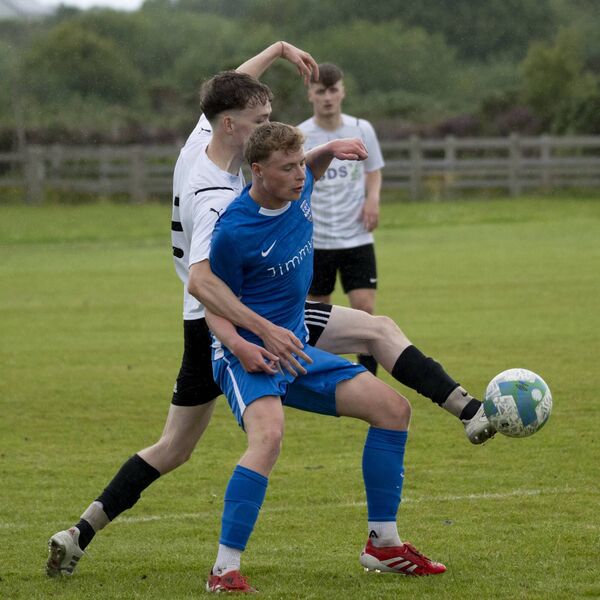 Ballina Town’s Ashton Judge (in blue) attempts to hold off with Shane Thomas.