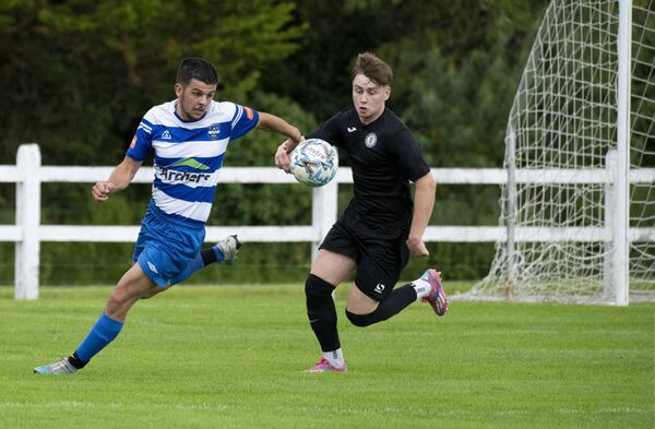 Martin Delaney, left, of Ballina Town, and Aiden Dunleavy of Swinford, challenge for the ball. 