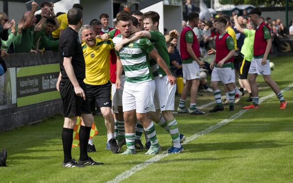 Eoghan Hughes, centre, celebrates his excellent goal with team manager Stevie Gavin and teammate Oran Groarke. 