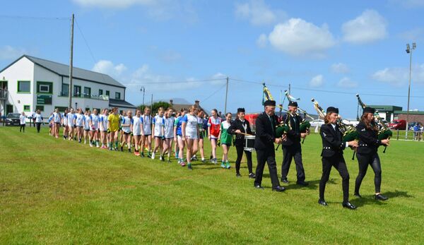 Players in the Girls under-14 competition parade behind local pipers in the 2024 Féile Chorn Acla. Picture: Grace Anne Doolin