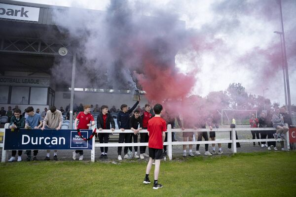Young Westport United fans bring colour and smoke to the Mayo Super Cup Final on Sunday. 