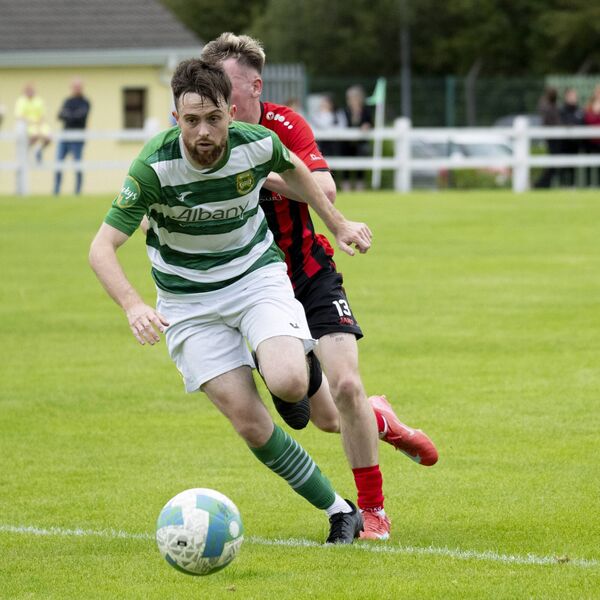 Celtic's Dylan Edwards beats United's Alex Halpin to the ball.