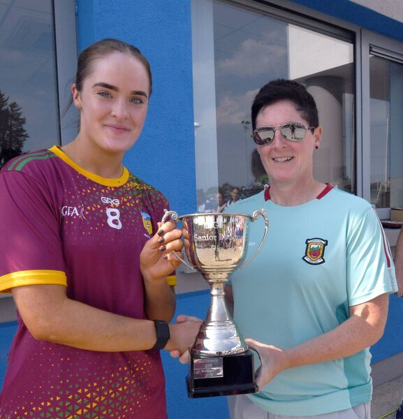 Mayo ladies senior football team manager, Diane O’Hora, presents Lahardane MacHales captain, Eilis Keane, with the Mayo LGFA Division 2 Cup.