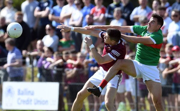 Crossmolina's Conor Loftus and Ballina Stephenites Mikey Murray battle for possession. 