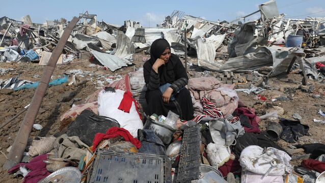<p>A displaced Palestinian woman sits with her belongings after an Israeli strike on at a camp for internally displaced people in Deir el-Balah in the central Gaza Strip last month. 	Picture: Eyad Baba//AFP via Getty Images</p>