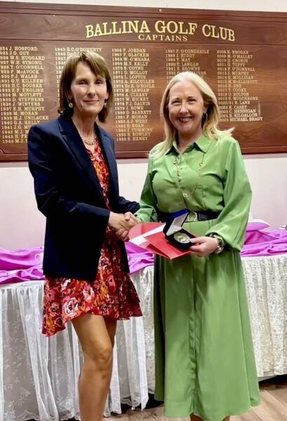 Sinead Fox (right) receives her prize from Ann Cawley, the Lady Captain of Ballina Golf Club, following her triumph at last month’s Ladies Captain’s Prize.