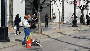 <p>A street performer cuts a forlorn figure on a street in Santa Monica, California. 	Picture: Liam Heffron</p>