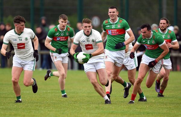 Luke O’Grady breaks out of midfield for the home side as Ballina's Dylan Thornton, Jack Irwin and Mike Murray all give chase. Picture: David Farrell